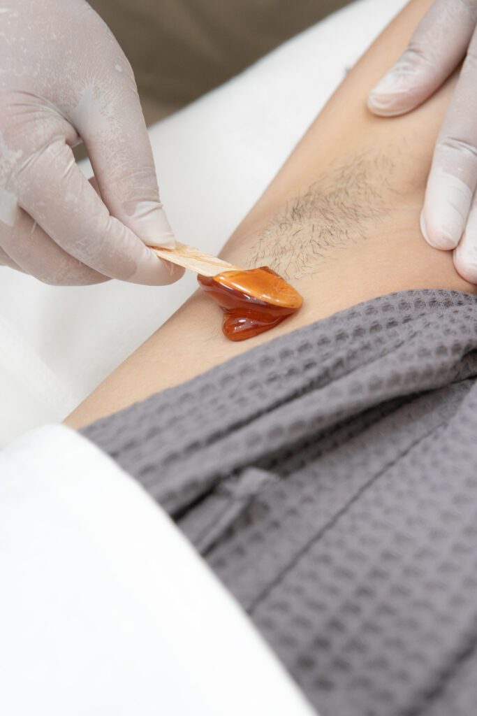Warm hard wax applied to an underarm at Bangkok Glow